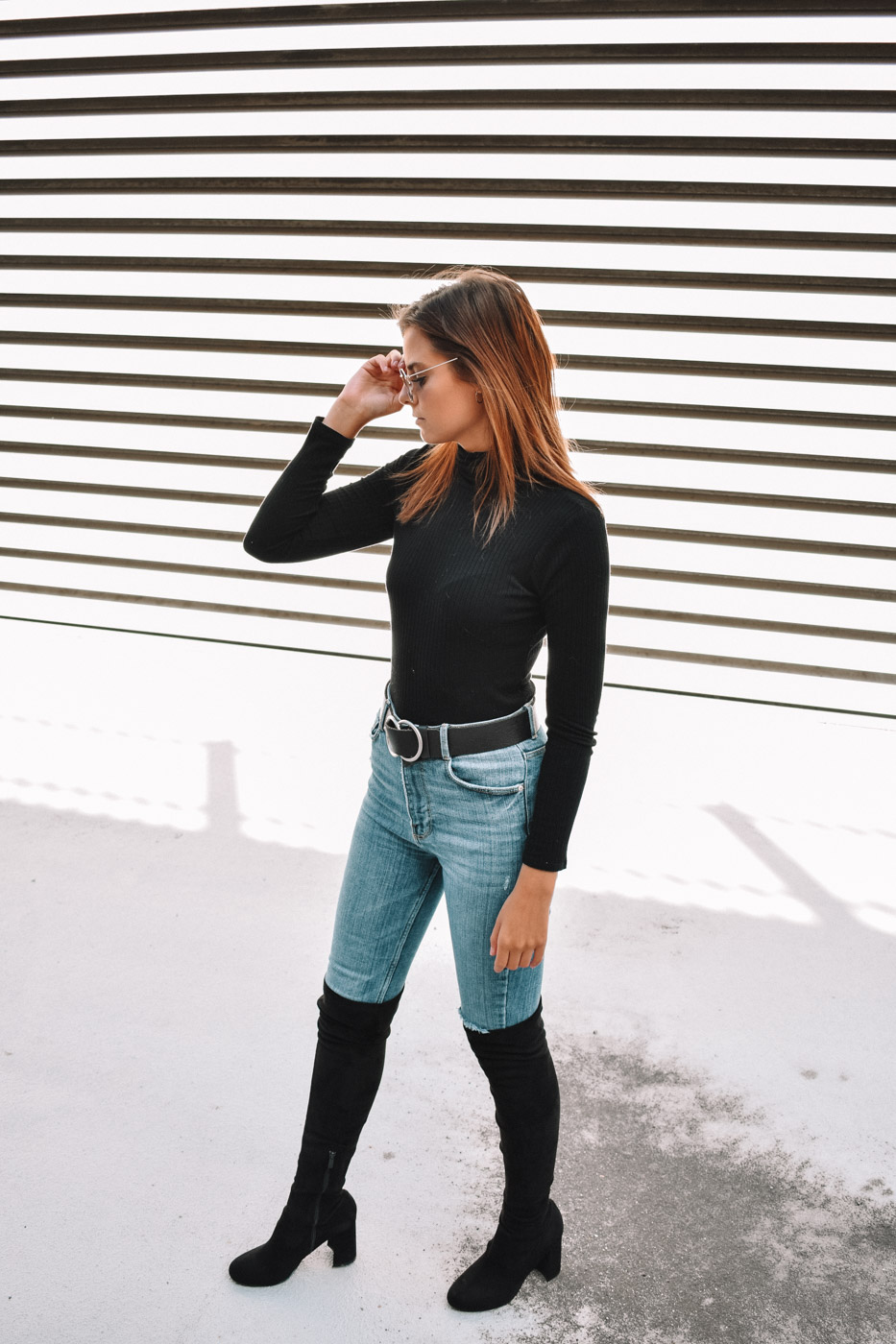 black knee high boots with white jeans